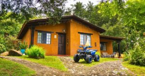 cabin house with a gravel driveway