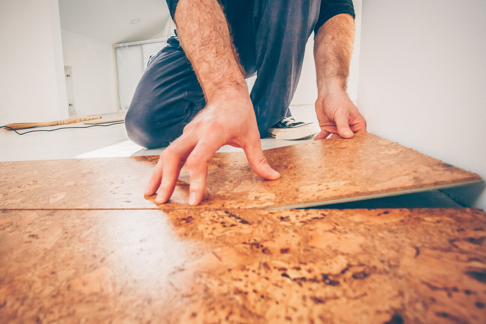 man laying cork flooring