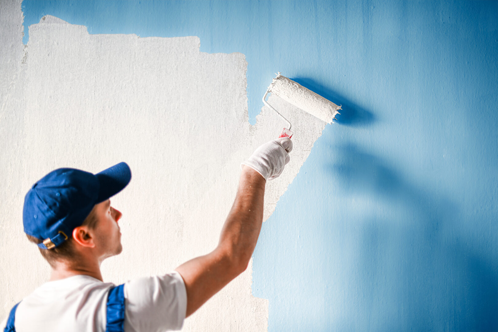 painting a wall with a paint roller