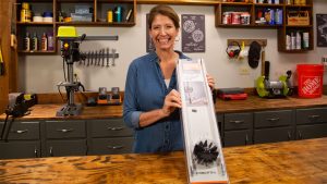 “Today’s Homeowner” Best New Products host Jodi Marks, displaying the Everbilt duct cleaner in her workshop