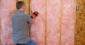 man installing insulation
