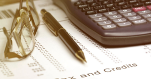 Calculator, pen, and tax form