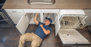 man installing a dishwasher