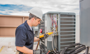HVAC tech checking a condensing unit
